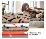 Three-layer Waterproof Pet Absorbent Pad with patterns of bones and paws, showcased with a woman and her dog.