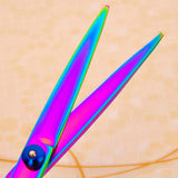 Pet grooming scissors with vibrant rainbow color blades for precision grooming.