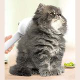 Pet Comb Self Cleaning Pets Hair Remover Brush For Dogs Grooming Tools Dematting Comb Built-in Mist Humidifier Pet Products in use on a grey cat.